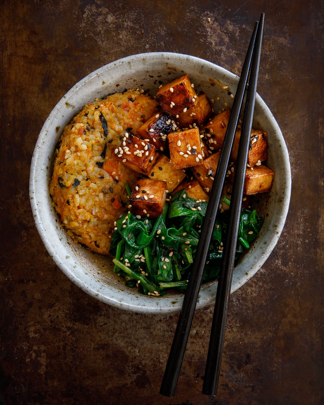 asian bowl of veggie burger, tofu and greens